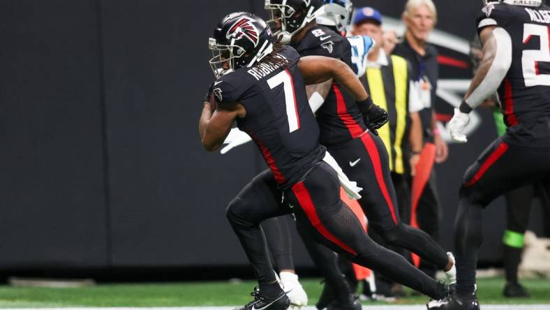 Sep 10, 2023; Atlanta, Georgia, USA; Atlanta Falcons running back Bijan Robinson (7) runs after a catch for a touchdown against the Carolina Panthers in the second quarter at Mercedes-Benz Stadium. Mandatory Credit: Brett Davis-USA TODAY Sports