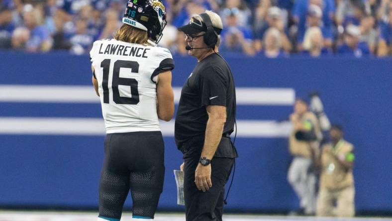 Sep 10, 2023; Indianapolis, Indiana, USA; Jacksonville Jaguars quarterback Trevor Lawrence (16) and head coach Doug Pederson talk during a timeout  in the second quarter against the Indianapolis Colts at Lucas Oil Stadium. Mandatory Credit: Trevor Ruszkowski-USA TODAY Sports