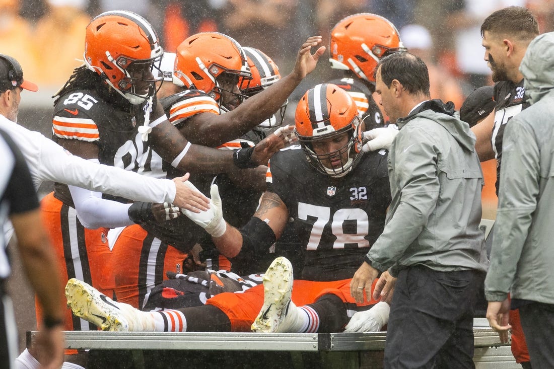 Sep 10, 2023; Cleveland, Ohio, USA; Cleveland Browns offensive tackle Jack Conklin (78) gets support from his teammates following an injury during the first half at Cleveland Browns Stadium. Mandatory Credit: Scott Galvin-USA TODAY Sports