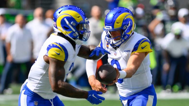 Sep 10, 2023; Seattle, Washington, USA; Los Angeles Rams quarterback Matthew Stafford (9) hands the ball off to Los Angeles Rams running back Cam Akers (3) during the first half against the Seattle Seahawks at Lumen Field. Mandatory Credit: Steven Bisig-USA TODAY Sports