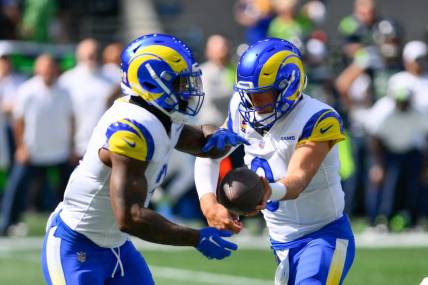 Sep 10, 2023; Seattle, Washington, USA; Los Angeles Rams quarterback Matthew Stafford (9) hands the ball off to Los Angeles Rams running back Cam Akers (3) during the first half against the Seattle Seahawks at Lumen Field. Mandatory Credit: Steven Bisig-USA TODAY Sports
