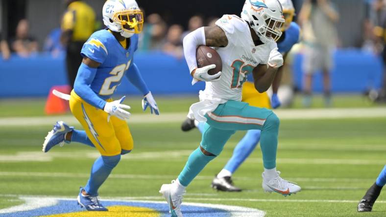 Sep 10, 2023; Inglewood, California, USA;   Miami Dolphins wide receiver Jaylen Waddle (17) is chased down by Los Angeles Chargers cornerback J.C. Jackson (27) and safety Alohi Gilman (32) after a pass play in the first half at SoFi Stadium. Mandatory Credit: Jayne Kamin-Oncea-USA TODAY Sports