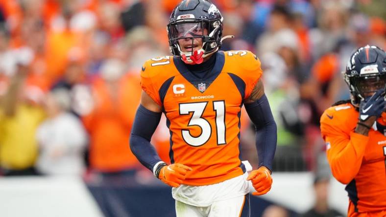 Sep 10, 2023; Denver, Colorado, USA; Denver Broncos safety Justin Simmons (31) reacts to a turnover in the third quarter against the Las Vegas Raiders at Empower Field at Mile High. Mandatory Credit: Ron Chenoy-USA TODAY Sports