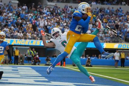 Sep 10, 2023; Inglewood, California, USA; Los Angeles Chargers cornerback J.C. Jackson (27) intercepts a pass intended for Miami Dolphins wide receiver Braxton Berrios (0) in the second half at SoFi Stadium. Mandatory Credit: Kirby Lee-USA TODAY Sports