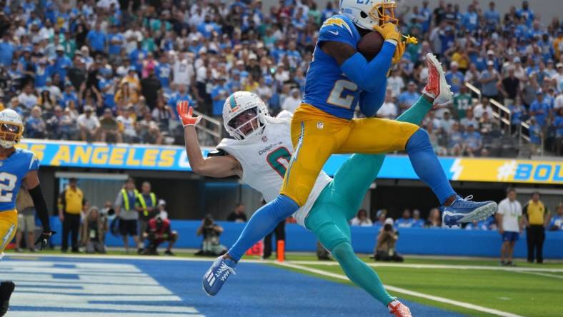 Sep 10, 2023; Inglewood, California, USA; Los Angeles Chargers cornerback J.C. Jackson (27) intercepts a pass intended for Miami Dolphins wide receiver Braxton Berrios (0) in the second half at SoFi Stadium. Mandatory Credit: Kirby Lee-USA TODAY Sports