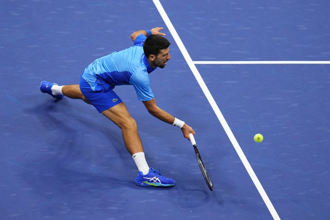 Sep 10, 2023; Flushing, NY, USA; Novak Djokovic of Serbia reaches for a forehand against Daniil Medvedev (not pictured) in the men's singles final in the men's singles final on day fourteen of the 2023 U.S. Open tennis tournament at USTA Billie Jean King National Tennis Center. Mandatory Credit: Danielle Parhizkaran-USA TODAY Sports