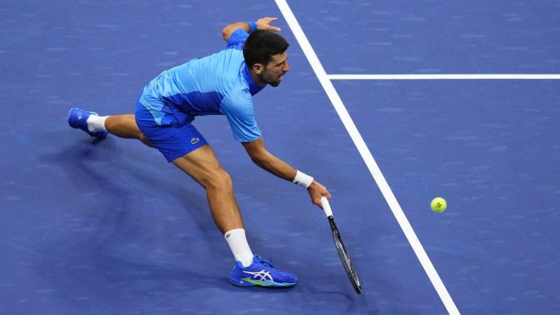 Sep 10, 2023; Flushing, NY, USA; Novak Djokovic of Serbia reaches for a forehand against Daniil Medvedev (not pictured) in the men's singles final in the men's singles final on day fourteen of the 2023 U.S. Open tennis tournament at USTA Billie Jean King National Tennis Center. Mandatory Credit: Danielle Parhizkaran-USA TODAY Sports