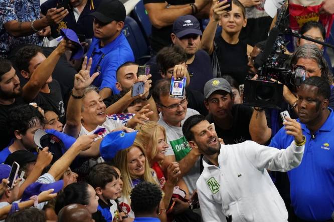 Sep 10, 2023; Flushing, NY, USA; Novak Djokovic of Serbia takes a selfie with fans after his match against Daniil Medvedev (not pictured) in the men's singles final in the men's singles final on day fourteen of the 2023 U.S. Open tennis tournament at USTA Billie Jean King National Tennis Center. Mandatory Credit: Danielle Parhizkaran-USA TODAY Sports