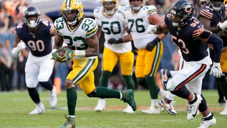 Green Bay Packers running back Aaron Jones (33) runs for a touchdown during second half of their game against the Chicago Bears on Sunday, Sept. 10, 2023 at Soldier Field in Chicago.