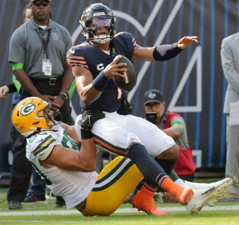Green Bay Packers linebacker Lukas Van Ness (90) tackles Chicago Bears quarterback Justin Fields (1) during their football game Sunday, September 10, 2023, at Soldier Field in Chicago, Ill.