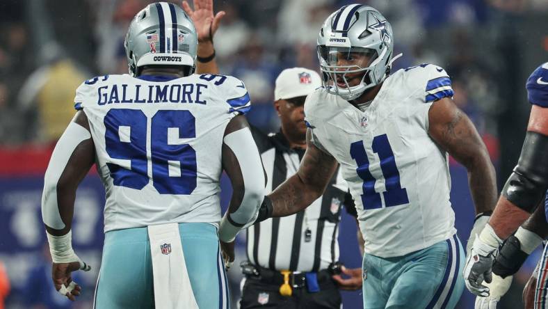 Sep 10, 2023; East Rutherford, New Jersey, USA; Dallas Cowboys linebacker Micah Parsons (11) celebrates a defensive stop with defensive tackle Neville Gallimore (96) during the first quarter against the New York Giants at MetLife Stadium. Mandatory Credit: Vincent Carchietta-USA TODAY Sports