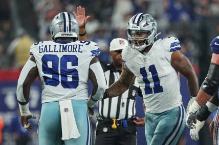 Sep 10, 2023; East Rutherford, New Jersey, USA; Dallas Cowboys linebacker Micah Parsons (11) celebrates a defensive stop with defensive tackle Neville Gallimore (96) during the first quarter against the New York Giants at MetLife Stadium. Mandatory Credit: Vincent Carchietta-USA TODAY Sports