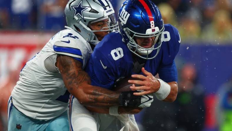 Sep 10, 2023; East Rutherford, New Jersey, USA; New York Giants quarterback Daniel Jones (8) is sacked by Dallas Cowboys linebacker Micah Parsons (11) during the first half at MetLife Stadium. Mandatory Credit: Ed Mulholland-USA TODAY Sports