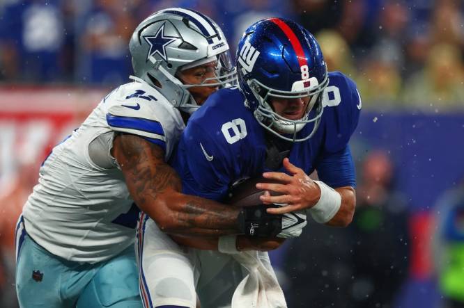Sep 10, 2023; East Rutherford, New Jersey, USA; New York Giants quarterback Daniel Jones (8) is sacked by Dallas Cowboys linebacker Micah Parsons (11) during the first half at MetLife Stadium. Mandatory Credit: Ed Mulholland-USA TODAY Sports