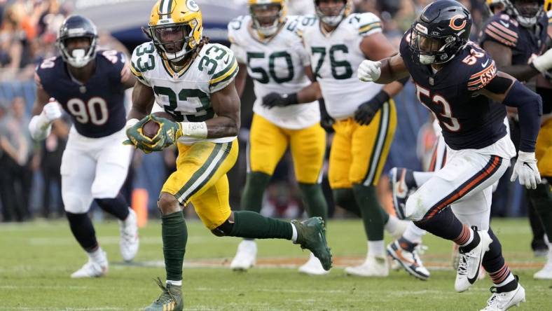 Sep 10, 2023; Chicago, Illinois, USA; Green Bay Packers running back Aaron Jones (33) runs for a touchdown during the second half of their game against the Chicago Bears at Soldier Field. Mandatory Credit: Mike De Sisti-USA TODAY Sports