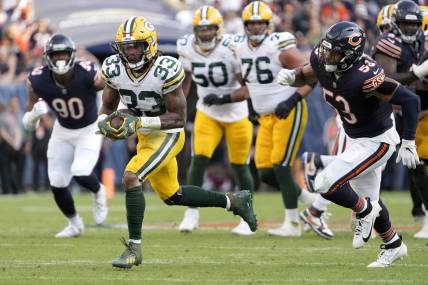 Sep 10, 2023; Chicago, Illinois, USA; Green Bay Packers running back Aaron Jones (33) runs for a touchdown during the second half of their game against the Chicago Bears at Soldier Field. Mandatory Credit: Mike De Sisti-USA TODAY Sports