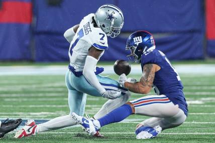 Sep 10, 2023; East Rutherford, New Jersey, USA; Dallas Cowboys cornerback Trevon Diggs (7) forces a fumble by New York Giants wide receiver Isaiah Hodgins (18) during the second half at MetLife Stadium. Mandatory Credit: Vincent Carchietta-USA TODAY Sports