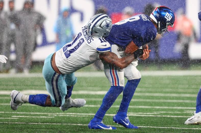 Sep 10, 2023; East Rutherford, New Jersey, USA; New York Giants quarterback Daniel Jones (8) is sacked by Dallas Cowboys linebacker Micah Parsons (11) during the second half at MetLife Stadium. Mandatory Credit: Ed Mulholland-USA TODAY Sports