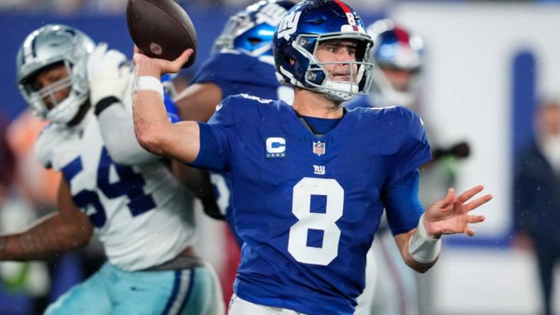 New York Giants quarterback Daniel Jones (8) throws a pass as he receives help from his offensive line. Sunday, September 10, 2023