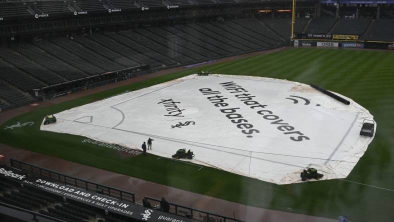 Sep 11, 2023; Chicago, Illinois, USA; A tarp covers the infield before game between the Kansas City Royals and the Chicago White Sox at Guaranteed Rate Field. The game was postponed due to rain until Tuesday. Mandatory Credit: Matt Marton-USA TODAY Sports