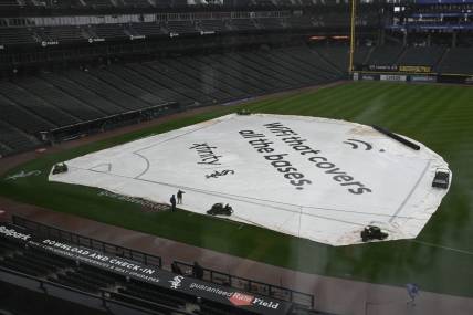 Sep 11, 2023; Chicago, Illinois, USA; A tarp covers the infield before game between the Kansas City Royals and the Chicago White Sox at Guaranteed Rate Field. The game was postponed due to rain until Tuesday. Mandatory Credit: Matt Marton-USA TODAY Sports