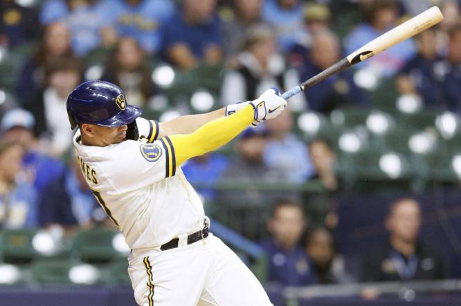Sep 11, 2023; Milwaukee, Wisconsin, USA;  Milwaukee Brewers shortstop Willy Adames (27) hits an RBI double during the third inning against the Miami Marlins at American Family Field. Mandatory Credit: Jeff Hanisch-USA TODAY Sports