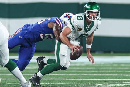 Sep 11, 2023; East Rutherford, New Jersey, USA; New York Jets quarterback Aaron Rodgers (8) is injured while being sacked by Buffalo Bills defensive end Leonard Floyd (56) during the first half at MetLife Stadium. Mandatory Credit: Vincent Carchietta-USA TODAY Sports