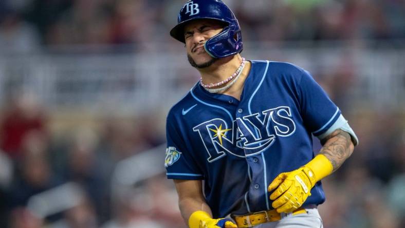 Sep 11, 2023; Minneapolis, Minnesota, USA; Tampa Bay Rays center fielder Jose Siri (22) reacts after getting hit in the hand by a pitch against the Minnesota Twins in the fifth inning at Target Field. Mandatory Credit: Jesse Johnson-USA TODAY Sports