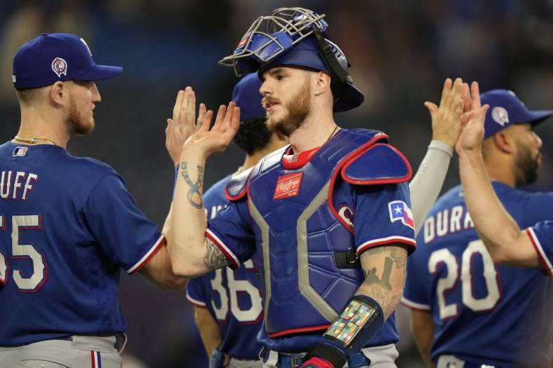 Sep 11, 2023; Toronto, Ontario, CAN; Texas Rangers catcher Jonah Heim (28) gets congratulated after a win over the Toronto Blue Jays at Rogers Centre. Mandatory Credit: John E. Sokolowski-USA TODAY Sports