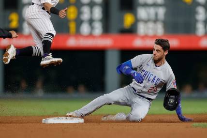 Sep 11, 2023; Denver, Colorado, USA; Chicago Cubs center fielder Cody Bellinger (24) slides into second on a double in the sixth inning against the Colorado Rockies at Coors Field. Mandatory Credit: Isaiah J. Downing-USA TODAY Sports