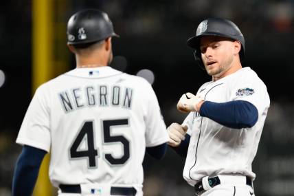 Sep 11, 2023; Seattle, Washington, USA; Seattle Mariners right fielder Jarred Kelenic (10) celebrates with first base coach Kristopher Negr  n (45) after hitting a single against the Los Angeles Angels during the fifth inning at T-Mobile Park. Mandatory Credit: Steven Bisig-USA TODAY Sports