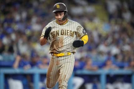 Sep 11, 2023; Los Angeles, California, USA; San Diego Padres second baseman Ha-Seong Kim (7) scores in the first inning against the Los Angeles Dodgers at Dodger Stadium. Mandatory Credit: Kirby Lee-USA TODAY Sports