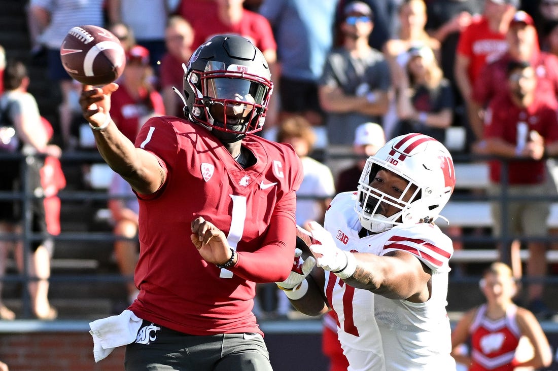 Sep 9, 2023; Pullman, Washington, USA; Washington State Cougars quarterback Cameron Ward (1) against Wisconsin Badgers defensive lineman Will McDonald (77) in the first half at Gesa Field at Martin Stadium. Mandatory Credit: James Snook-USA TODAY Sports