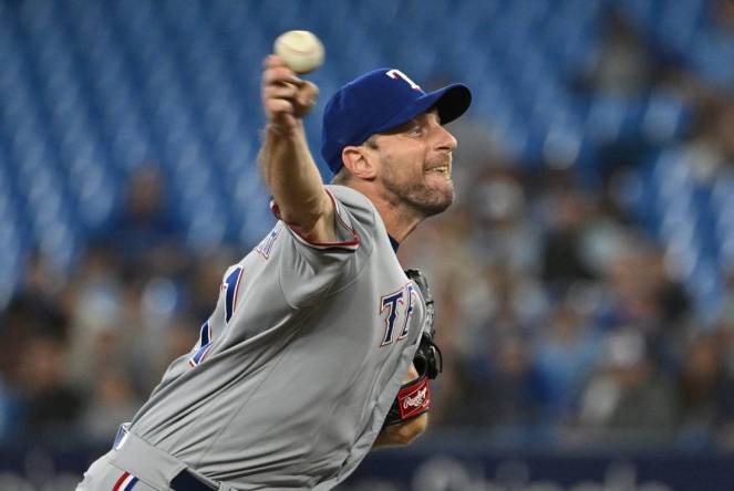 Sep 12, 2023; Toronto, Ontario, CAN;   Texas Rangers starting pitcher Max Scherzer (31) delivers a pitch against the Toronto Blue Jays in the first inning at Rogers Centre. Mandatory Credit: Dan Hamilton-USA TODAY Sports