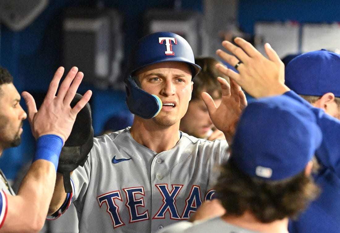 Sep 12, 2023; Toronto, Ontario, CAN;  Texas Rangers shortstop Corey Seager (5) celebrate with team mates in the dugout after scoring against the Toronto Blue Jays in the sixth inning at Rogers Centre. Mandatory Credit: Dan Hamilton-USA TODAY Sports