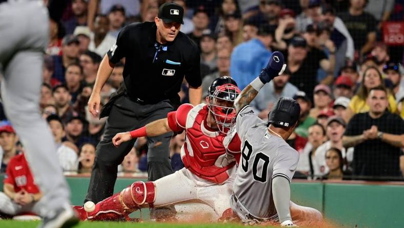 Sep 12, 2023; Boston, Massachusetts, USA; New York Yankees left fielder Everson Pereira (80) slides safe into home plate covered by Boston Red Sox catcher Connor Wong (12) during the fifth inning at Fenway Park. Mandatory Credit: Eric Canha-USA TODAY Sports