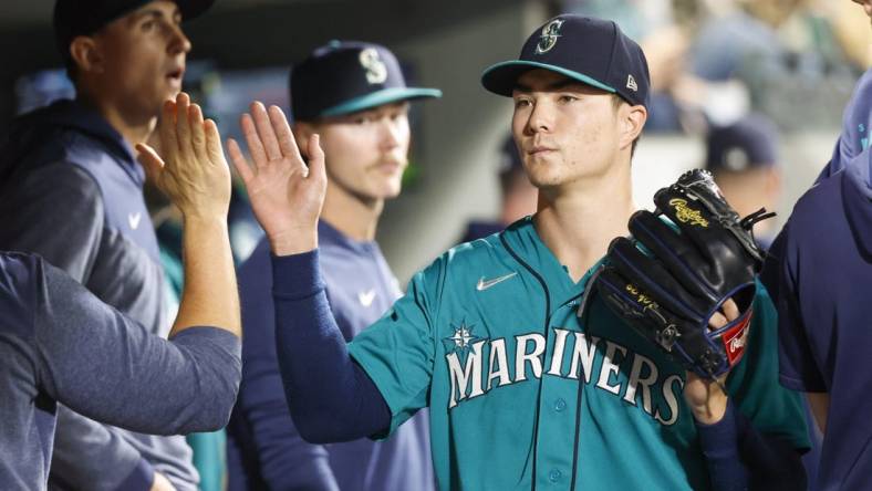 Sep 12, 2023; Seattle, Washington, USA; Seattle Mariners starting pitcher Bryan Woo (33) high-fives teammates and staff in the dugout during a sixth inning pitching change against the Los Angeles Angels at T-Mobile Park. Mandatory Credit: Joe Nicholson-USA TODAY Sports