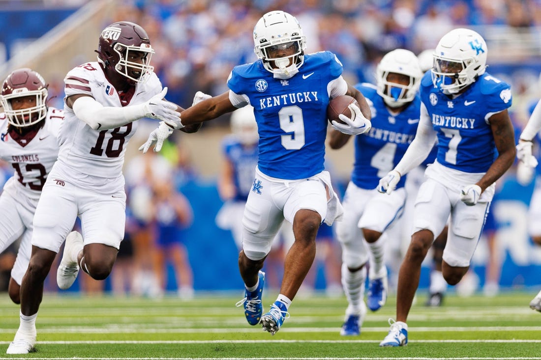 Sep 9, 2023; Lexington, Kentucky, USA; Kentucky Wildcats wide receiver Tayvion Robinson (9) runs down the field against Eastern Kentucky Colonels linebacker Cornelius Evans (18) during the third quarter at Kroger Field. Mandatory Credit: Jordan Prather-USA TODAY Sports