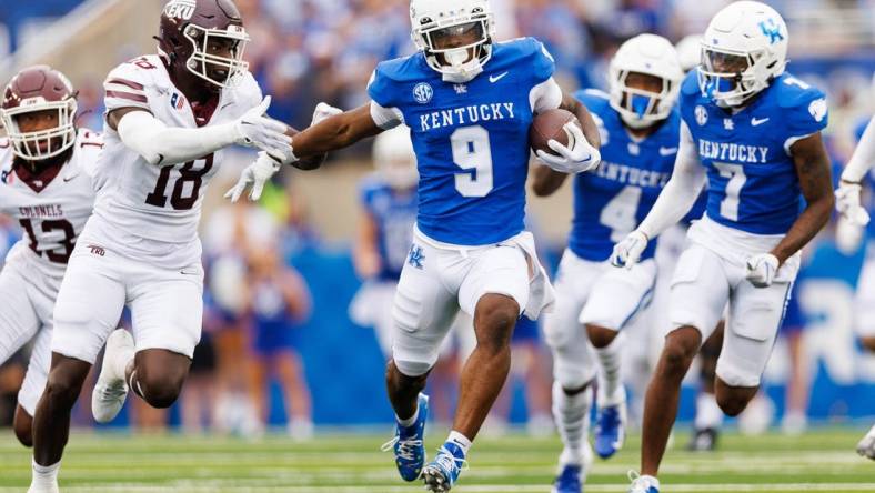 Sep 9, 2023; Lexington, Kentucky, USA; Kentucky Wildcats wide receiver Tayvion Robinson (9) runs down the field against Eastern Kentucky Colonels linebacker Cornelius Evans (18) during the third quarter at Kroger Field. Mandatory Credit: Jordan Prather-USA TODAY Sports