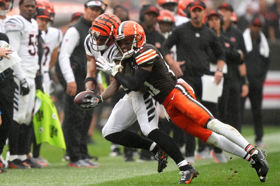 Cincinnati Bengals wide receiver Ja'Marr Chase (1) is pushed out of bounds after a catch by Cleveland Browns cornerback Denzel Ward (21) in the third quarter of an NFL football game between the Cincinnati Bengals and Cleveland Browns, Sunday, Sept. 10, 2023, at Cleveland Browns Stadium in Cleveland.