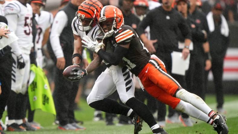 Cincinnati Bengals wide receiver Ja'Marr Chase (1) is pushed out of bounds after a catch by Cleveland Browns cornerback Denzel Ward (21) in the third quarter of an NFL football game between the Cincinnati Bengals and Cleveland Browns, Sunday, Sept. 10, 2023, at Cleveland Browns Stadium in Cleveland.