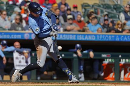 Sep 13, 2023; Minneapolis, Minnesota, USA; Tampa Bay Rays third baseman Curtis Mead (25) hits an RBI double against the Minnesota Twins in the third inning at Target Field. Mandatory Credit: Bruce Kluckhohn-USA TODAY Sports