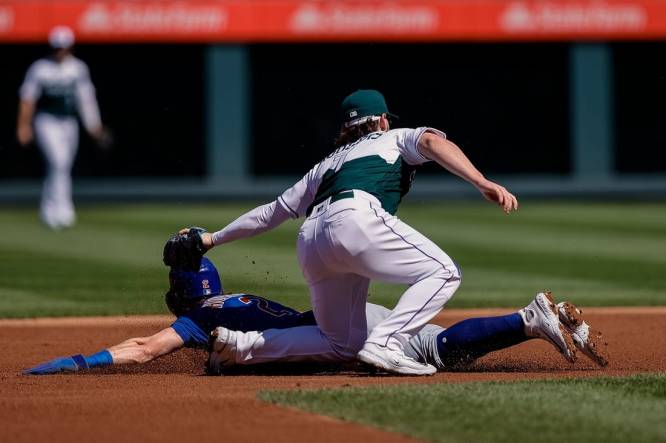 Sep 13, 2023; Denver, Colorado, USA; Chicago Cubs second baseman Nico Hoerner (2) is tagged out attempting to steal second against Colorado Rockies second baseman Brendan Rodgers (7) in the first inning at Coors Field. Mandatory Credit: Isaiah J. Downing-USA TODAY Sports