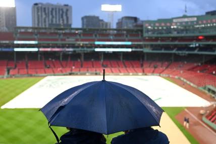 Sep 13, 2023; Boston, Massachusetts, USA; Fans wait in the rain before a game between the New York Yankees and the Boston Red Sox at Fenway Park. Mandatory Credit: Brian Fluharty-USA TODAY Sports