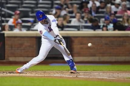 Sep 13, 2023; New York City, New York, USA; New York Mets first baseman Pete Alonso (20) hits an RBI single against the Arizona Diamondbacks during the first inning at Citi Field. Mandatory Credit: Gregory Fisher-USA TODAY Sports