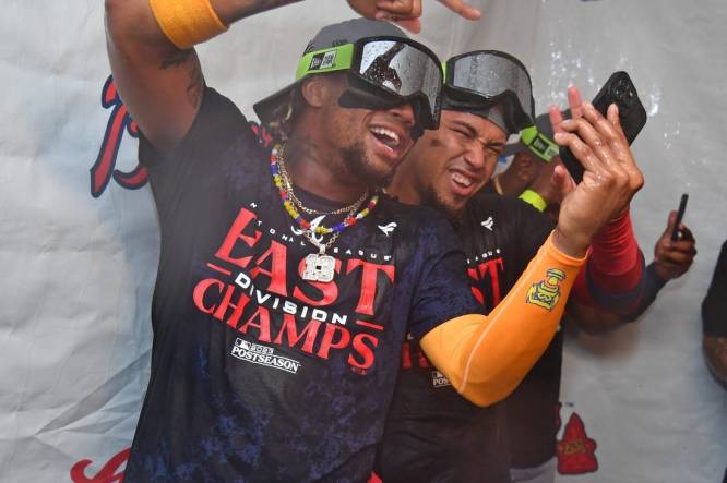 Sep 13, 2023; Philadelphia, Pennsylvania, USA; Atlanta Braves right fielder Ronald Acuna Jr. (13) and shortstop Orlando Arcia (11) celebrate their 6th straight National League East title in the locker room after win against the Philadelphia Phillies at Citizens Bank Park. Mandatory Credit: Eric Hartline-USA TODAY Sports