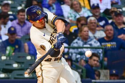 Sep 14, 2023; Milwaukee, Wisconsin, USA; Milwaukee Brewers left fielder Tyrone Taylor (15) hits a double to drive in a run in the seventh inning against the Miami Marlins at American Family Field. Mandatory Credit: Benny Sieu-USA TODAY Sports