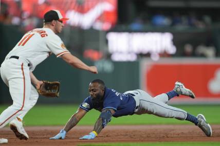Sep 14, 2023; Baltimore, Maryland, USA; Tampa Bay Rays outfielder Randy Arozarena (56) slides in safely with a triple driving in two runs in the third inning against the Baltimore Orioles at Oriole Park at Camden Yards. Mandatory Credit: Mitch Stringer-USA TODAY Sports