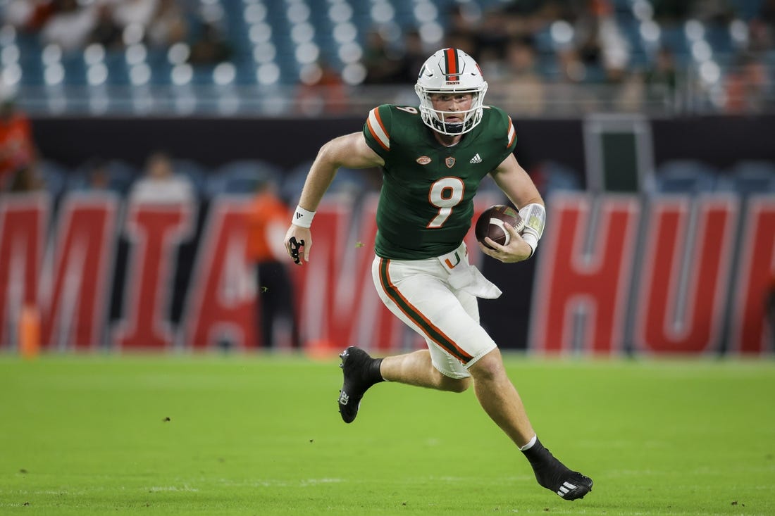 Sep 14, 2023; Miami Gardens, Florida, USA; Miami Hurricanes quarterback Tyler Van Dyke (9) runs with the football against the Bethune Cookman Wildcats during the first quarter at Hard Rock Stadium. Mandatory Credit: Sam Navarro-USA TODAY Sports