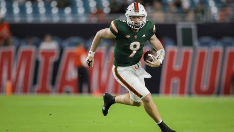 Sep 14, 2023; Miami Gardens, Florida, USA; Miami Hurricanes quarterback Tyler Van Dyke (9) runs with the football against the Bethune Cookman Wildcats during the first quarter at Hard Rock Stadium. Mandatory Credit: Sam Navarro-USA TODAY Sports